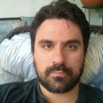 Portrait of a man with black hair and black beard