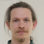 Portrait of a man with long hair, tied into a ponytail